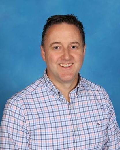 smiling man in plaid shirt