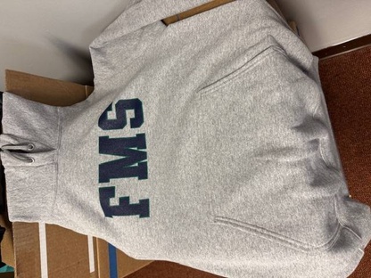 A gray hooded sweatshirt with the letters FMS in bold blue and green lettering.