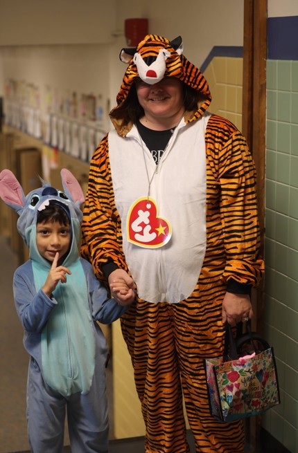 A student and teacher dressed up in costumes for Halloween 