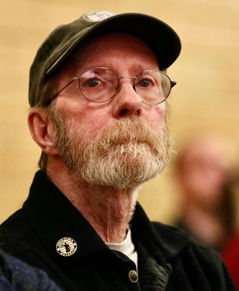 A veteran sits during the ceremony