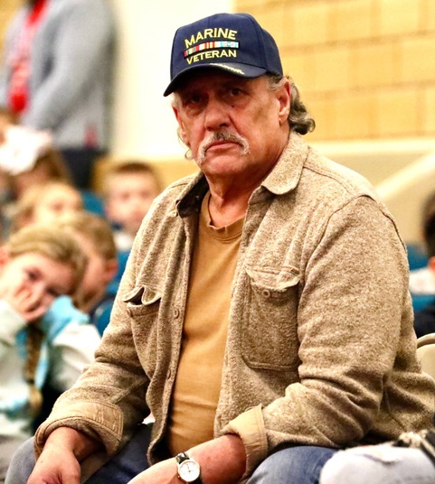 A veteran sits during the ceremony