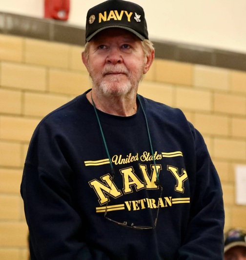 A veteran stands at the assembly