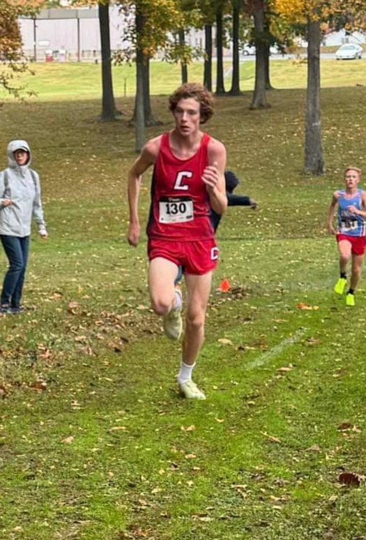 1 person running wearing red uniform with red "c"