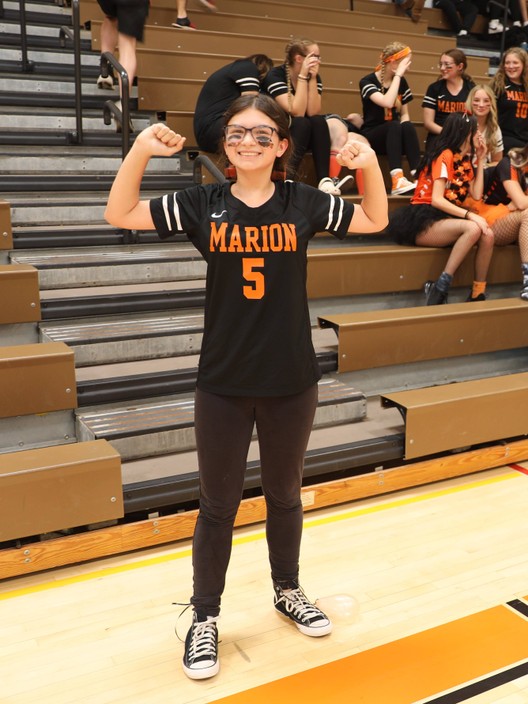 A student celebrates after winning the balloon stomping contest