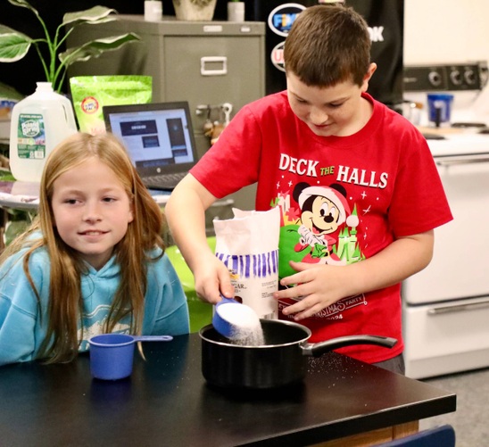 Two students make snacks at mini camp