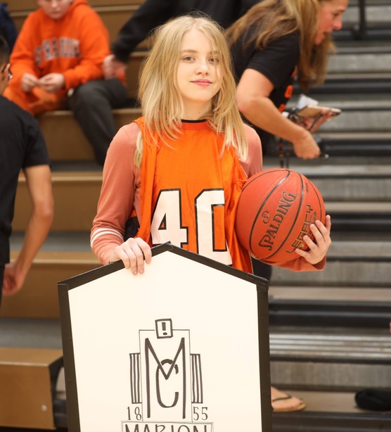 A student celebrates after winning the relay race 