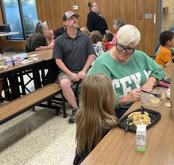 grandparent and grandchild at breakfast table