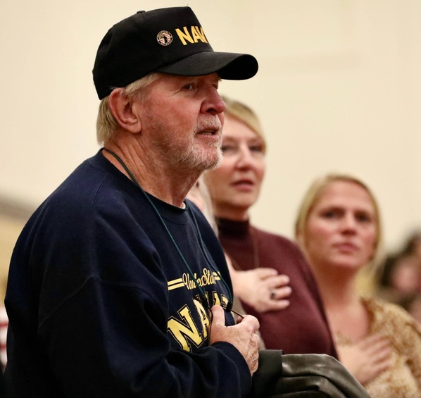 A veteran stands for the Pledge of Allegiance.