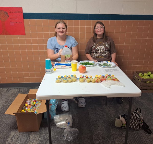 Students sit at a table 