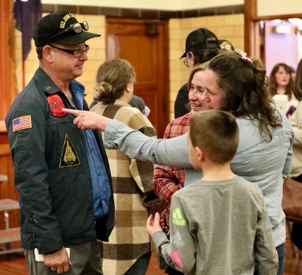 A veteran talks with people after the ceremony