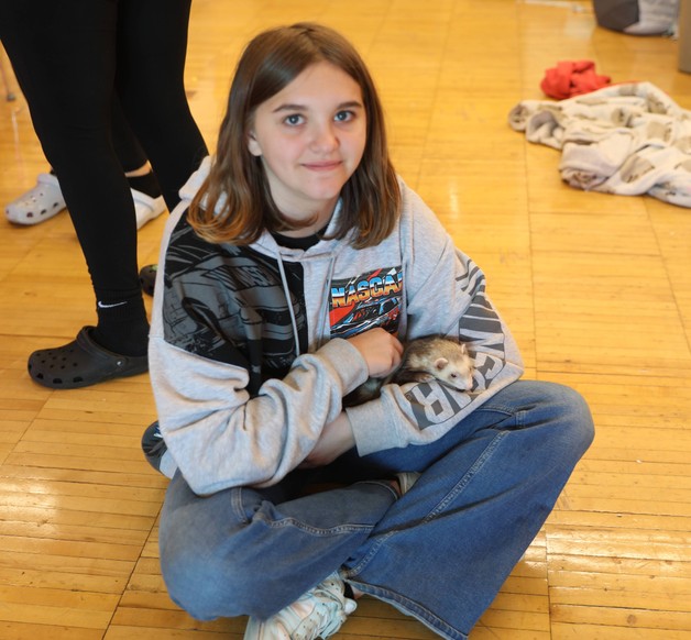 An FFA member holds an animal