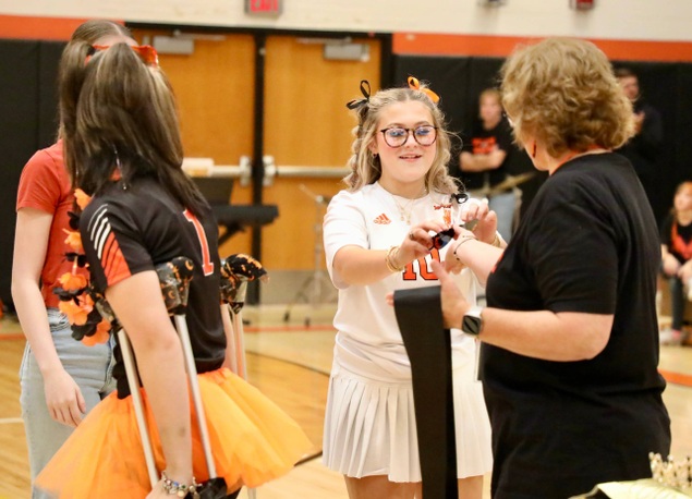 A member of the Homecoming Court receives a gift 