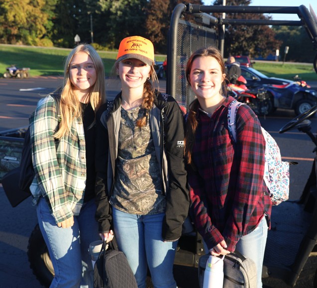 Students pose in the parking lot before heading in for class