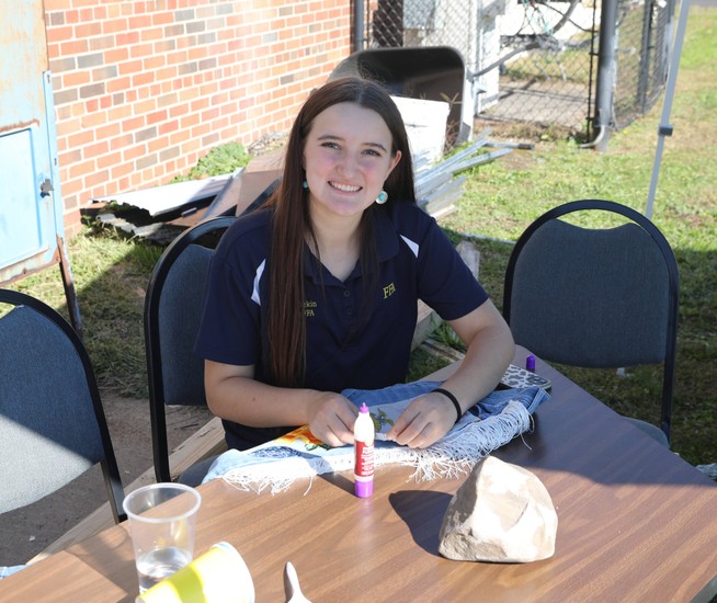 An FFA member sits at a table