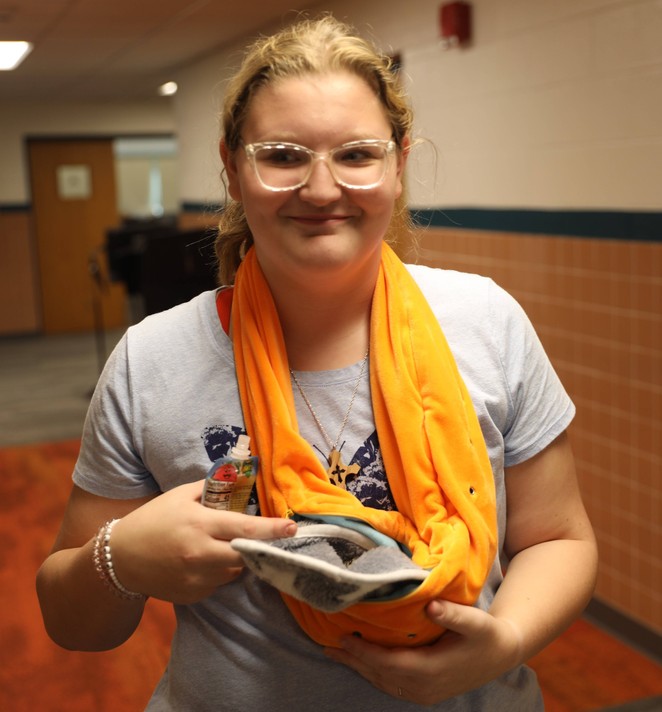 An FFA member holds an animal