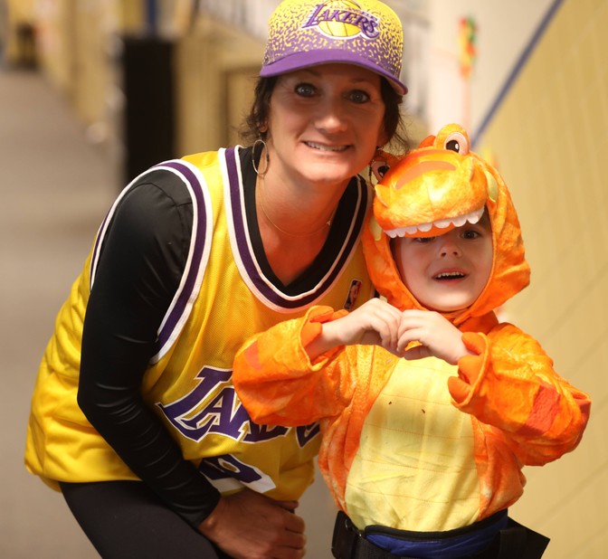 A student and staff member dressed in costumes 