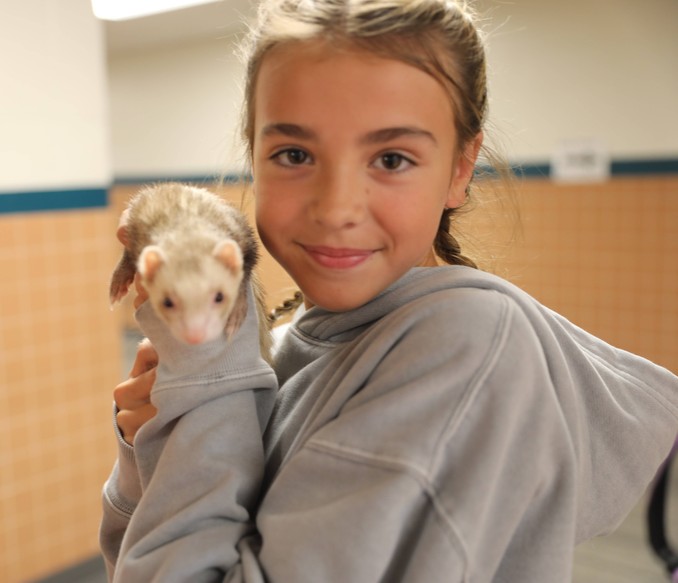 A student holds an animal