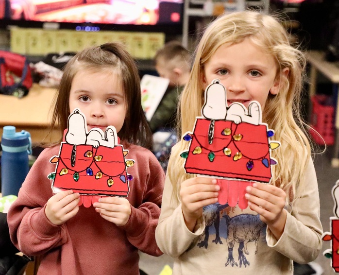 Students show their Snoopy arts and crafts project.