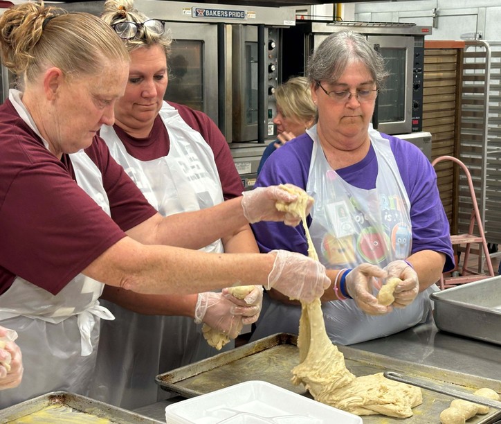 3 people work with dough