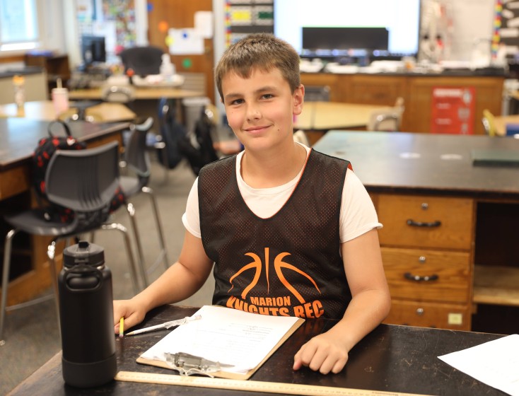 A student wears a basketball jersey for jersey day