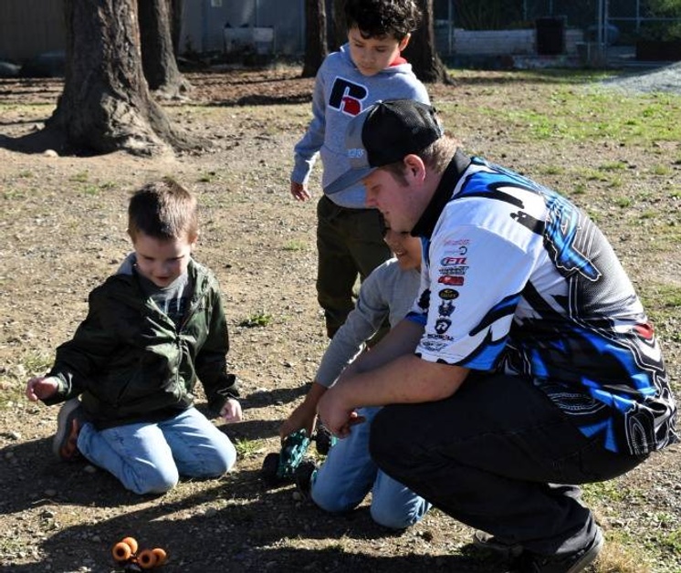 Carson Williams with students on playground