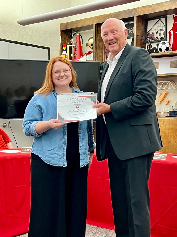 Picture of Rebecca Jones receiving Silver Axe Award from Board President, Jay Wyatt