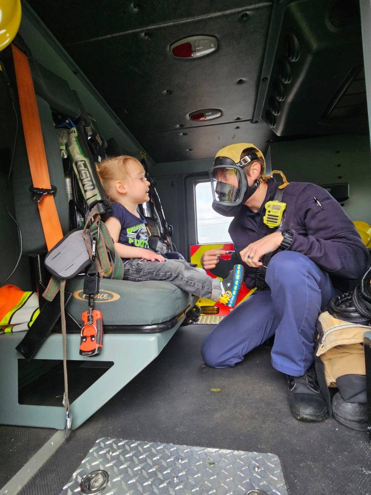 fire fighter in mask with preschooler