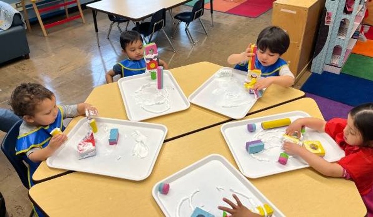 preschool students make foam shape structure