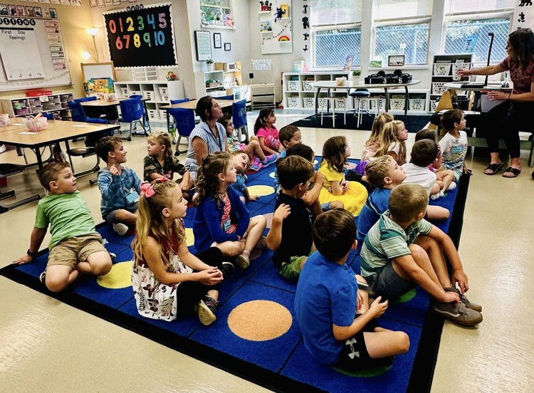 Kindergarten class listens to their teacher