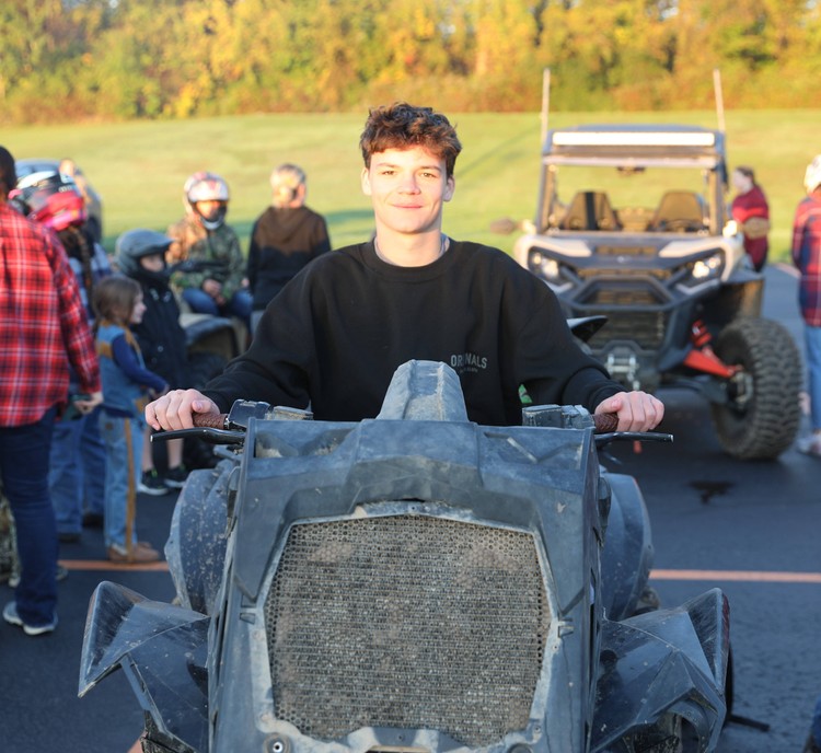 A student sits on a four-wheeler