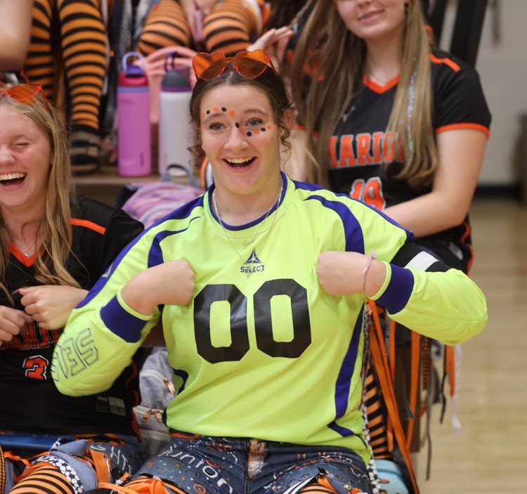 A student does the chicken dance at the pep assembly 