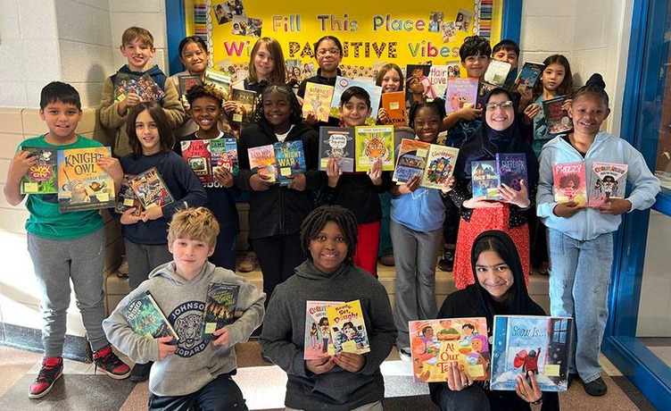 Johnson students posing with books given by Chris Long Foundation