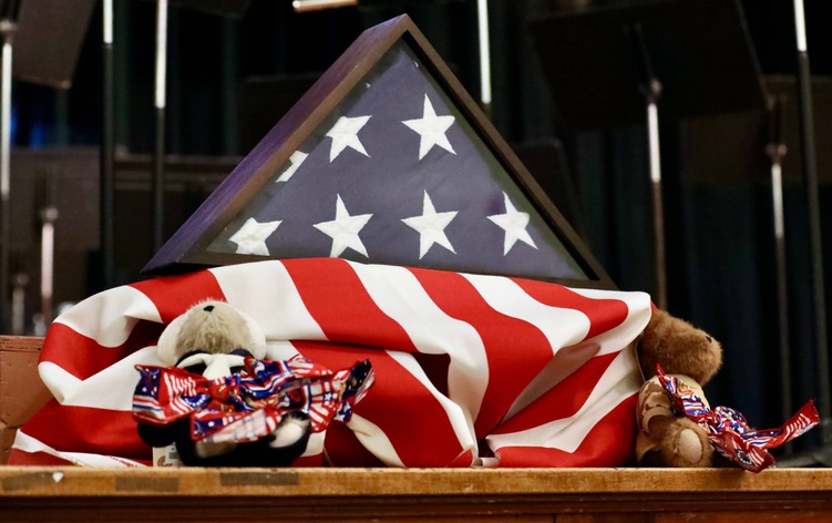 A display on stage features the American flag 