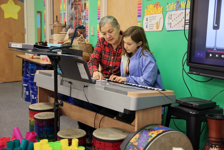 A W.M. Irvin Elementary student playing on a piano.