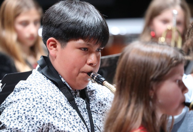 A member of the Fifth and Sixth Grade Band performs.