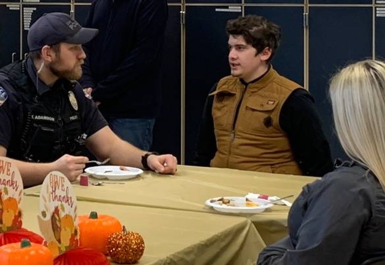 students and first responders eating together