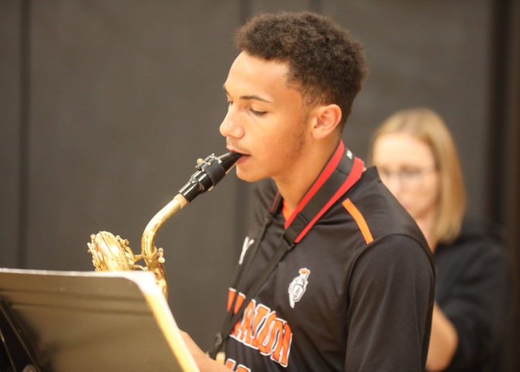 A student plays the saxophone