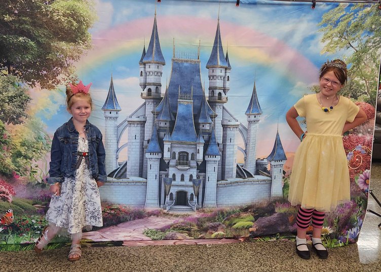 2 people in front of castle backdrop