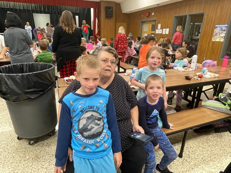 grandparent and grandchildren at breakfast table