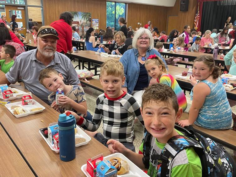 grandparents and grandchildren at breakfast table