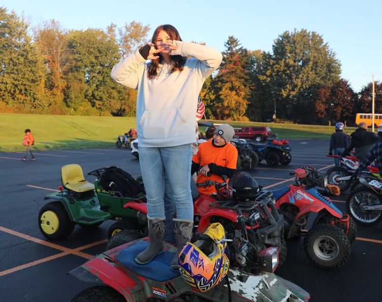 A student stands on a four-wheeler