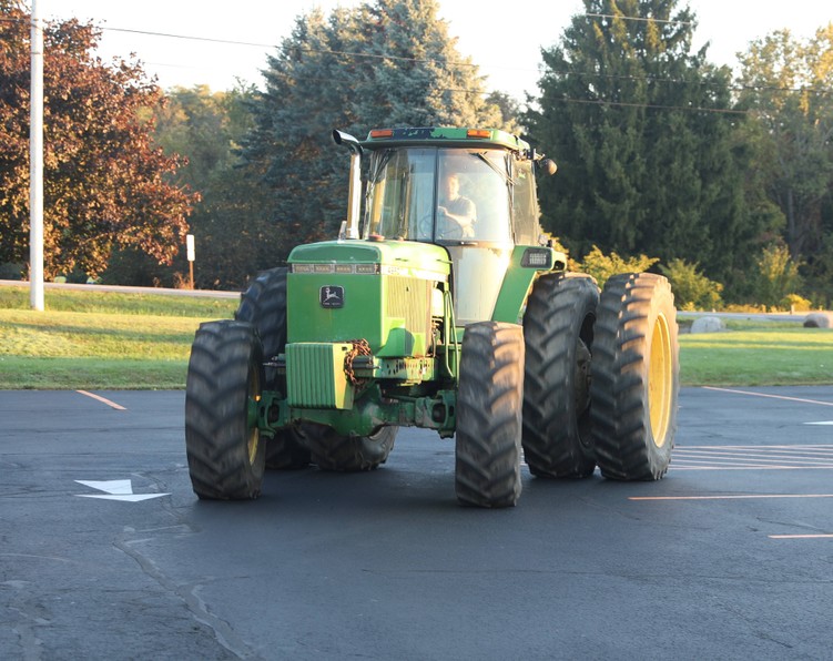 A tractor pulls into the parking lot