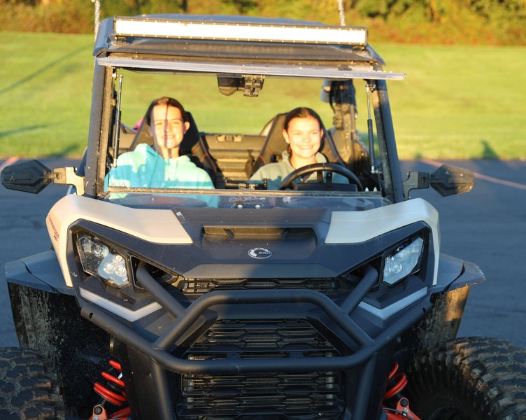 Students sit in a four-wheeler