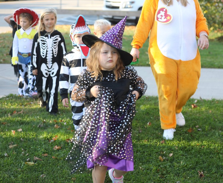 Students in costumes walk in the K-2 costume parade 