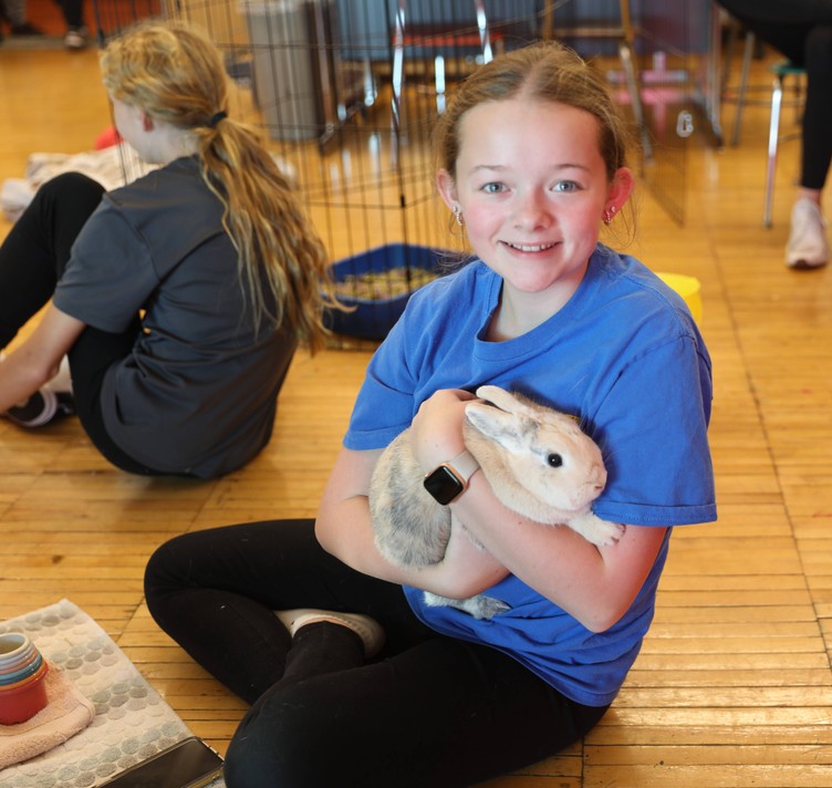 An FFA member holds a rabbit