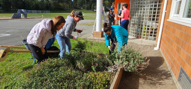 staff gardening and painting doors at Hillcrest Elementary