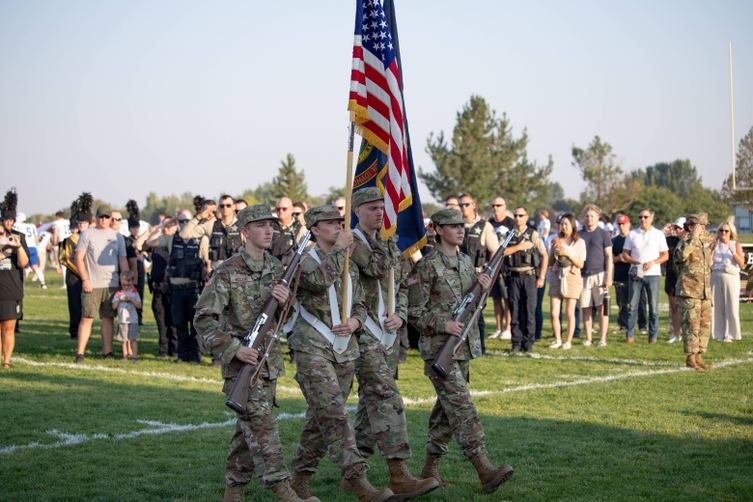 Members of junior ROTC carry US Flag for ceremony