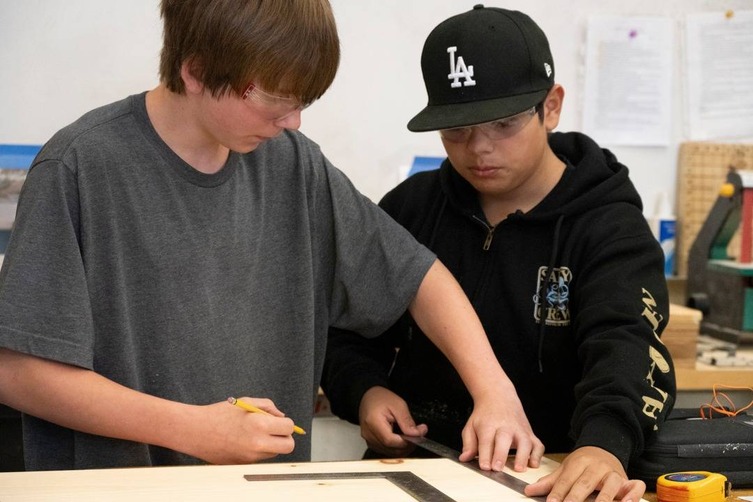 high school students measuring wood