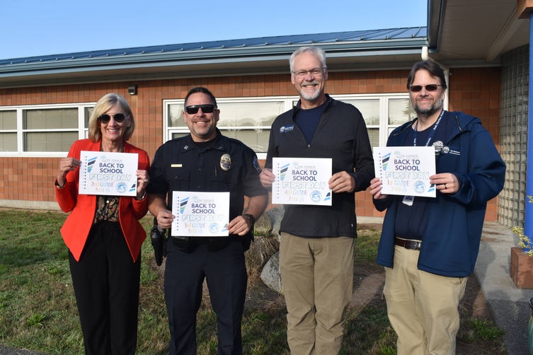 school board president lynn goebel, police officer, assistant superintendent, director of information services