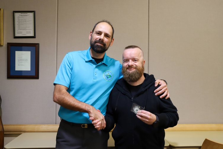 Photo of Dan Hebert and Brian Enos shaking hands